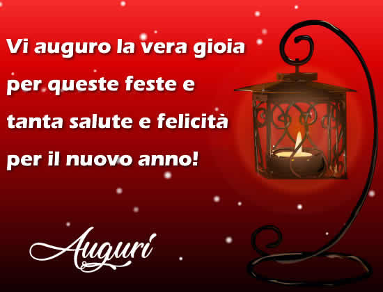 Immagine dai colori rosso natalizio con lampada e messaggio di auguri: Vi auguro la vera gioia per queste feste e tanta salute e felicità per il nuovo anno!!.